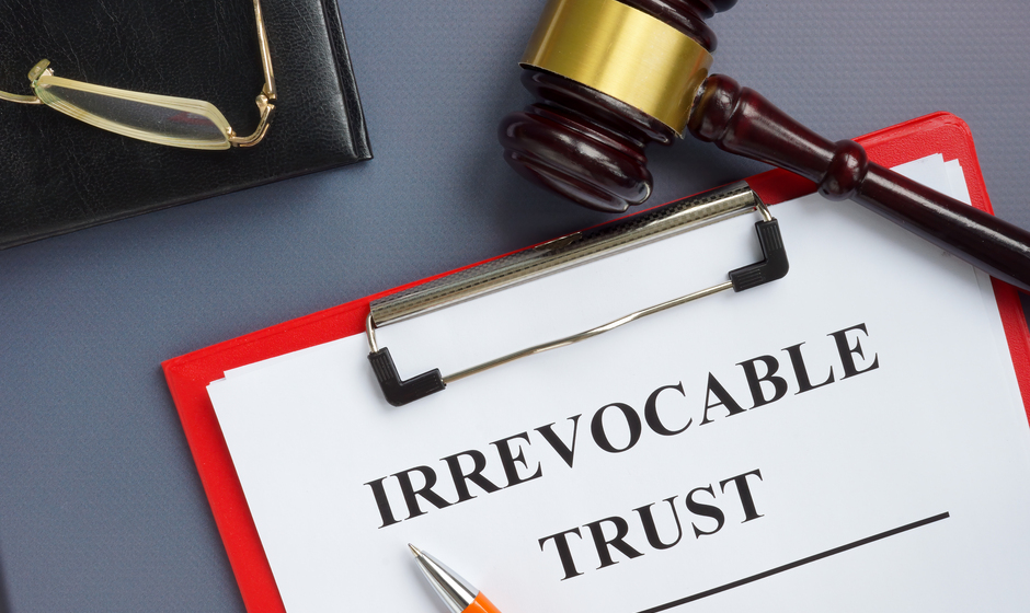 Irrevocable trust document on the clipboard and gavel.