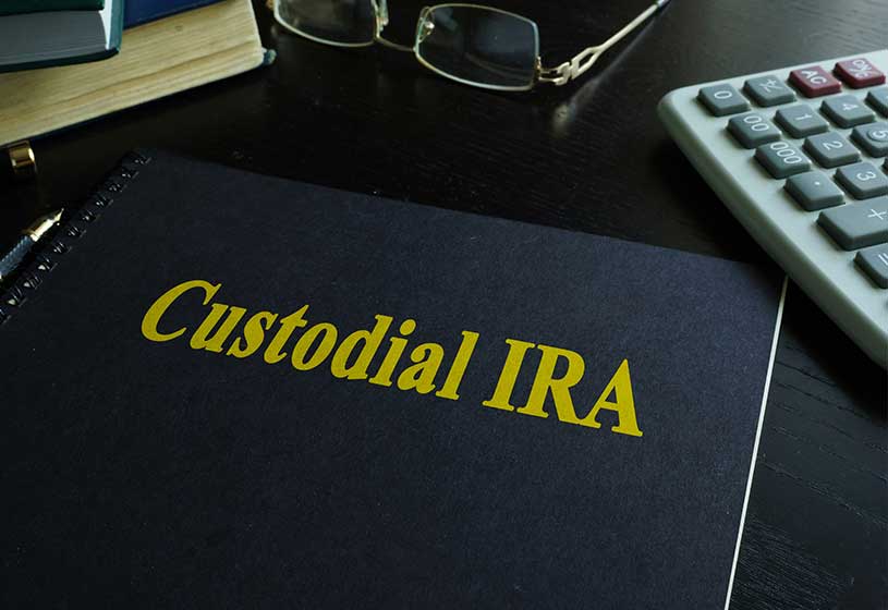 Book with title Custodial IRA on a desk
